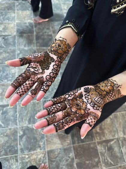 A two-hand view of a lighter Pakistani floral design, perfect for someone who wants a beautiful but not-so-heavy look.