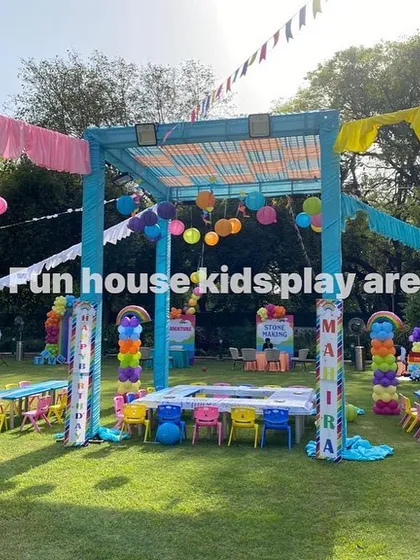 A wide shot capturing the scale of this colorful outdoor event. Our rainbow tables and chairs are spread across the lawn, ready to welcome many young guests.