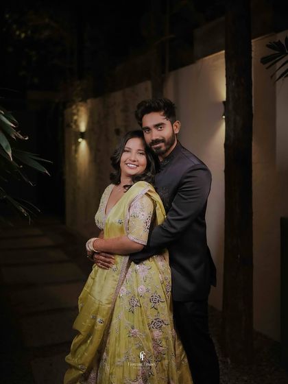 A warm, evening portrait of the engaged couple embracing. The soft lighting creates a romantic and cozy atmosphere.