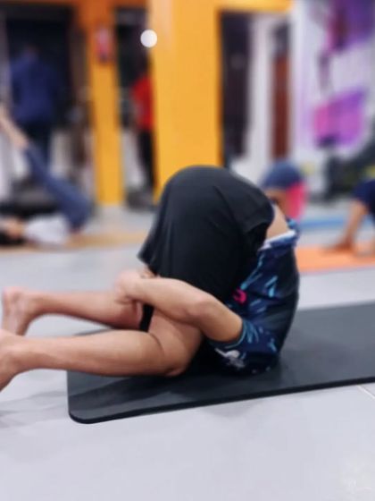 Karnapidasana (Knee to Ear Pose) is a deep forward compression pose that calms the nervous system and provides an intense stretch to the entire spine.