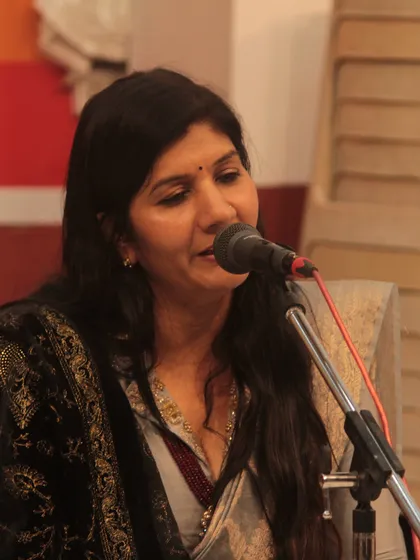 A student's gentle expression as she sings, reflecting the subtle emotions of the composition.