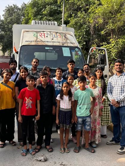 Our Kala-Car course students stand proudly in front of the Music Bus. This visit was their first introduction to a mobile recording studio, sparking excitement for recording their own original songs.