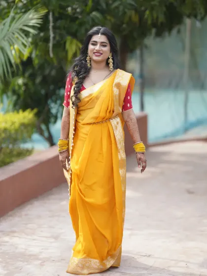 The bride walking gracefully, her yellow Haldi outfit looking bright and beautiful.