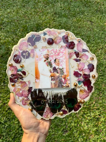 Another beautiful example of a custom geode-style plaque. This piece includes preserved flowers, a wedding photo, their hashtag, and delicate peacock feathers.