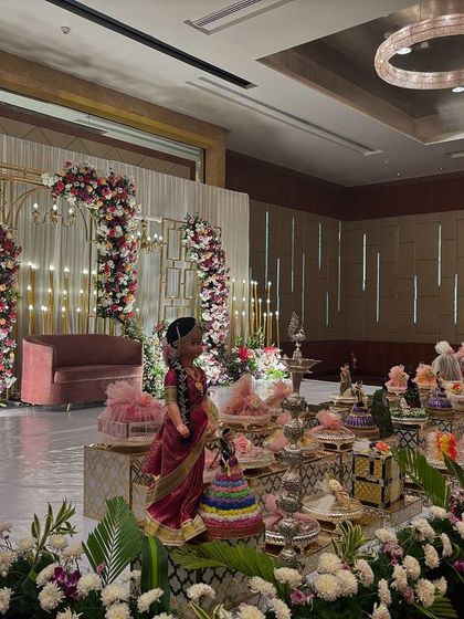 An angled shot of the modern geometric stage, highlighting the warm lighting and floral arrangements.