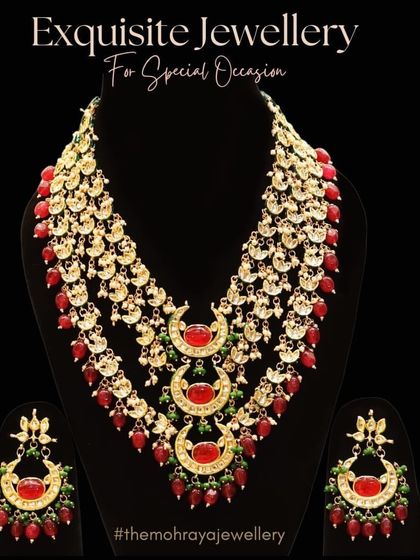 An exquisite multi-layered rani haar with red stones and crescent motifs. This is a perfect statement piece for a grand bridal entry.