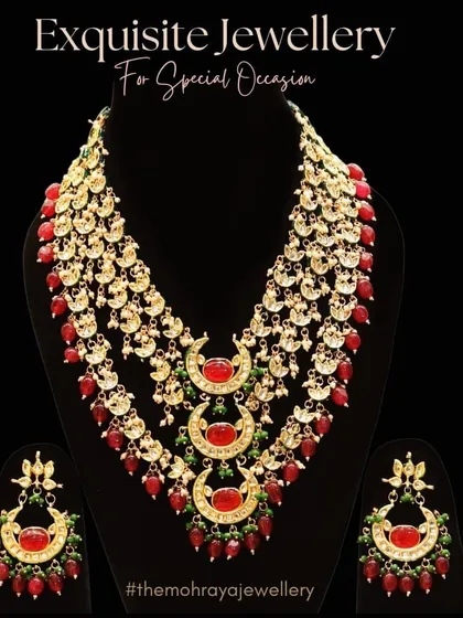 An exquisite multi-layered rani haar with red stones and crescent motifs. This is a perfect statement piece for a grand bridal entry.