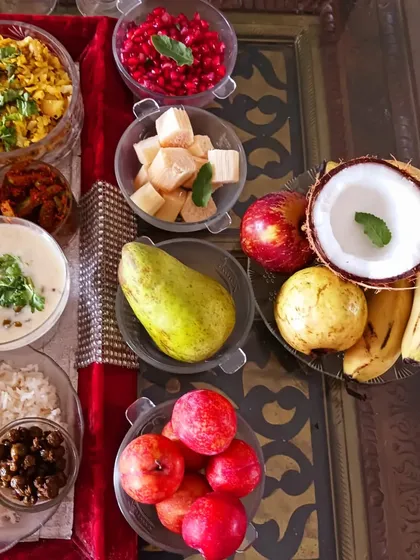 The fruit and fresh offerings from the 56 Bhog. Fresh fruits like pomegranate and guava, along with coconut and plant-based doodh poha, are an integral part of the traditional feast.