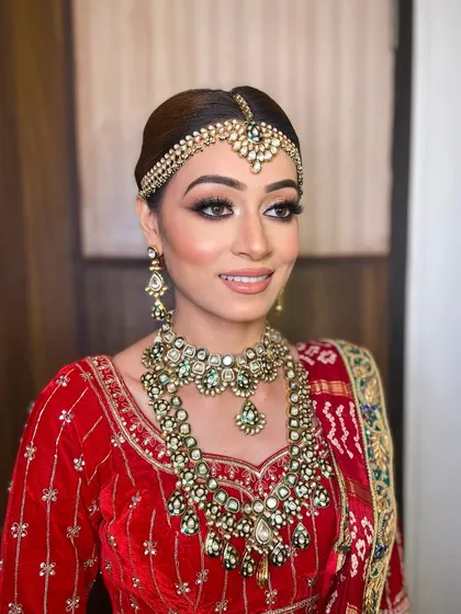 The complete royal bride look for Bhavika. Her radiant skin and timeless makeup ensured she looked stunning from every angle on her wedding day.