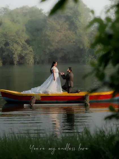 A wide shot of the couple in a boat, surrounded by the morning mist on the lake. This image captures a sense of peace and endless love.