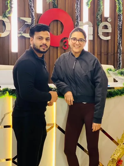 A member and trainer posing together at our decorated reception desk. The festive decorations and smiling faces capture the warm community spirit during the holidays.