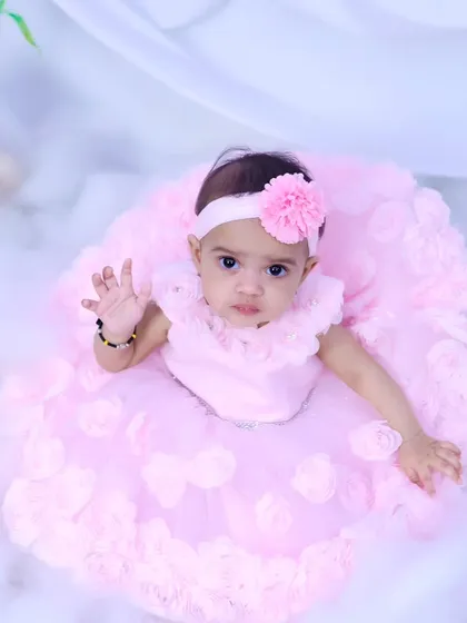 This little fairy is waving to the camera from her magical cloud.