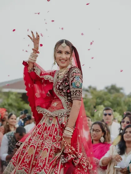 The happiest brides are the prettiest! A candid shot of the bride dancing her way down the aisle, showered with petals.