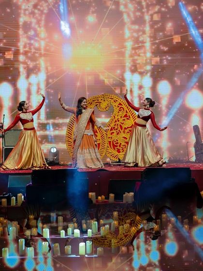 A bride's performance with backup dancers and large paisley-shaped props. The thematic elements and grand scale made this a memorable act.