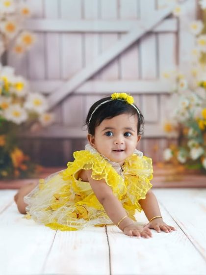 Crawling towards the next adventure! This milestone photo captures a baby on the move against a beautiful floral backdrop.