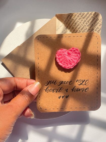 "You gave my heart a home." A cute card with a tiny crochet heart on rustic brown paper. The perfect little note for your favorite person.