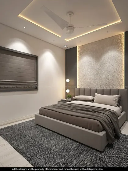 A guest bedroom designed for pure relaxation. The textured accent wall, soft lighting, and simple, elegant bed create a serene and welcoming atmosphere.