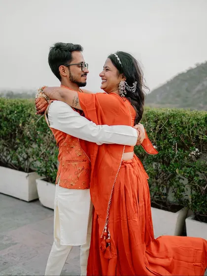 A warm, happy embrace between Sugandha and Ashish. This candid photo perfectly captures the love and comfort they share, a quiet moment amidst their Haldi celebrations.