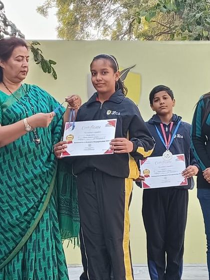 A student receives an award for her performance in a robotics event. We celebrate every achievement to encourage continuous learning and innovation among our young creators.