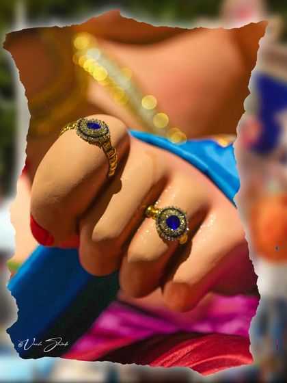 A macro shot focusing on the rings adorning the idol's hand, highlighting the fine details.