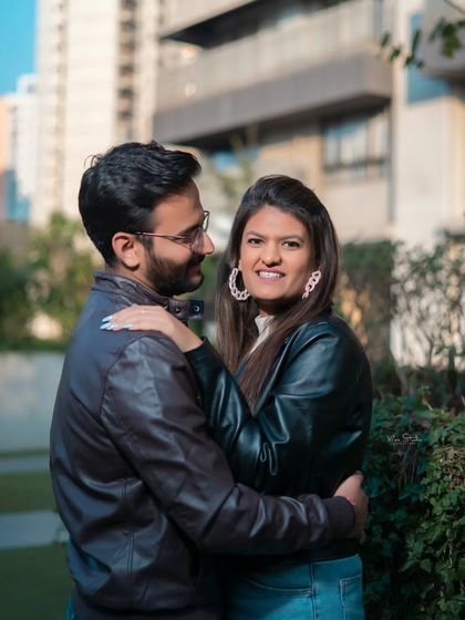 A lovely, candid moment between the couple. The soft, natural lighting and genuine smiles make this urban portrait feel intimate and real.