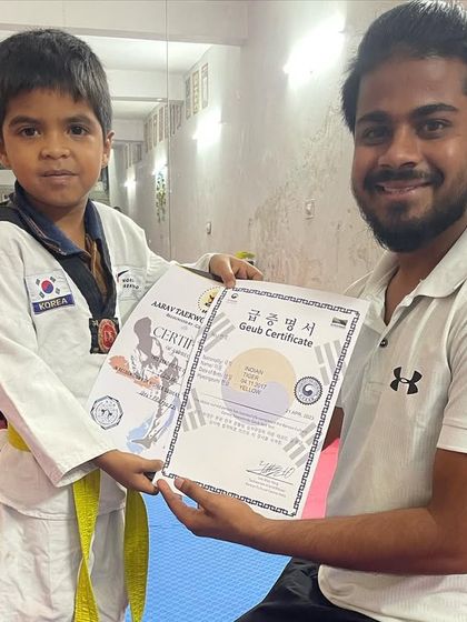 Another student happy to receive his official Geub certificate. These certifications validate their hard work and connect them to the global Taekwondo community.