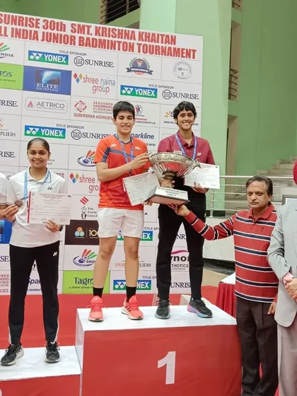 **Celebrating a Doubles Victory.** The winners' podium for the U-19 Girls' Doubles, with our champion Anmol Kharb and her partner taking the first-place spot.