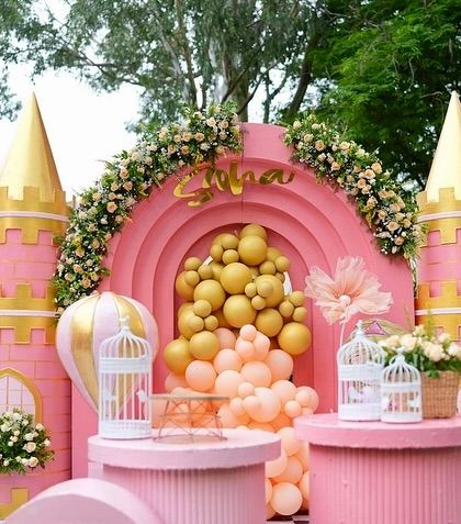 Soha's Disneyland-inspired castle in vibrant pink and gold. This magnificent backdrop features multiple turrets, a balloon-filled arch, and is perfect for a princess who loves all things bright and royal.