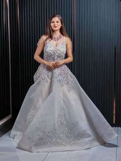 A full view of the magnificent silver gown, showcasing its grand silhouette. This is an ideal rental for making an unforgettable entrance at any formal event.
