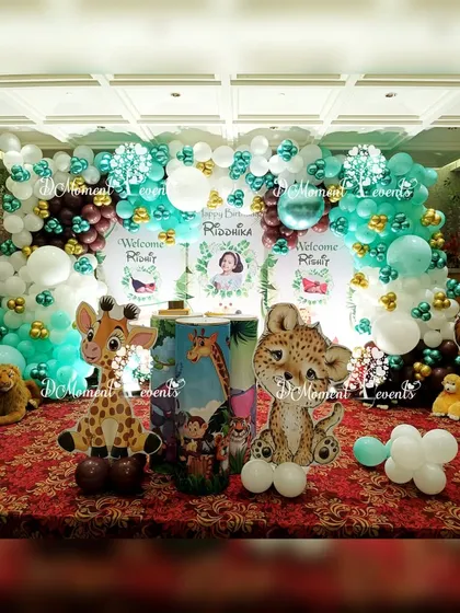 A cute and colorful jungle-themed stage setup. This design uses softer, more cartoonish animal cutouts like a zebra, giraffe, and leopard, making it perfect for a first birthday or baby welcome party.