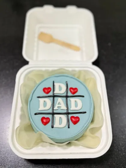 A thoughtful and personal bento cake for Dad. These small, individual-sized cakes are perfect for intimate celebrations and can be customized with any message or design, like this fun tic-tac-toe theme.