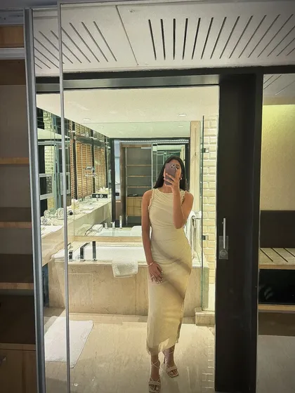 Another view of the draped dress, showing the elegant fit and the luxurious bathroom setting. Sometimes the location is the best accessory.