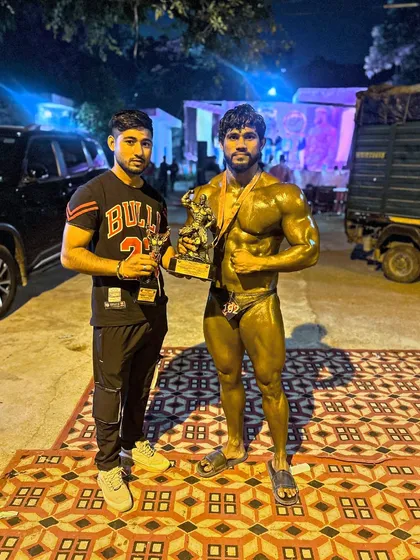 After securing two gold medals, posing with my trophy and a teammate. The work is hard, but the victory is sweet.