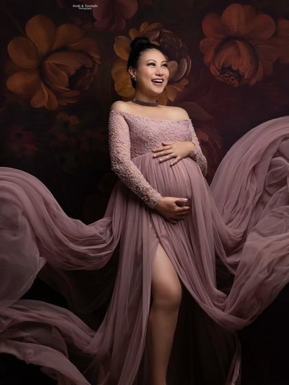 The pure happiness of expecting. We love capturing these candid moments of laughter during our studio sessions. The movement in the gown adds a beautiful, ethereal quality to the photograph.