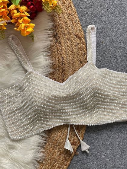 A full front view of the white pearl spaghetti blouse, alterable up to size 44.