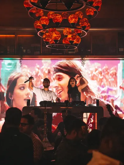Shameless Mani on the mic with a huge visual of us on the screen behind. Our branding is strong and adds to the professional feel of our takeover events.