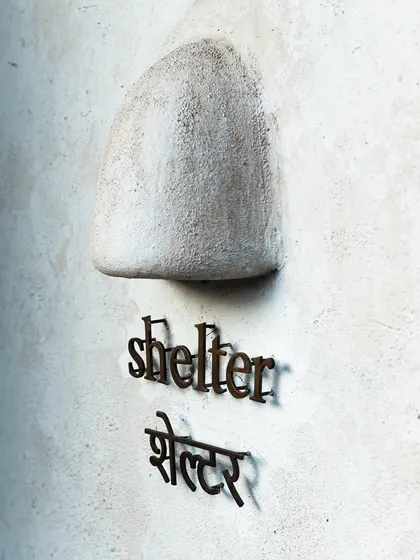 The exterior signage of Shelter by Javaphile. This shot introduces the cafe and its charming, minimalist aesthetic.