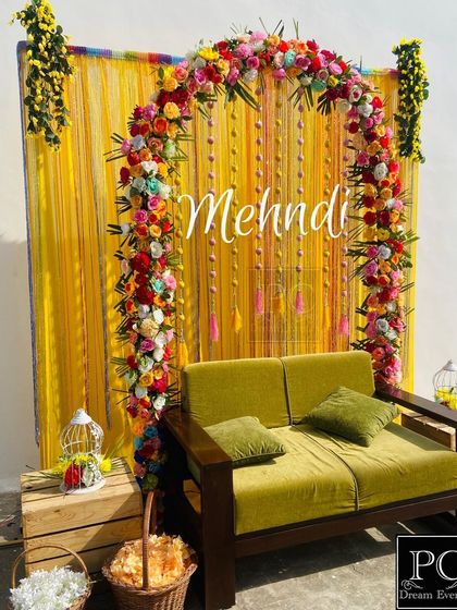 This angle shows the beautiful contrast between the olive green sofa and the bright yellow and multi-colored floral backdrop.