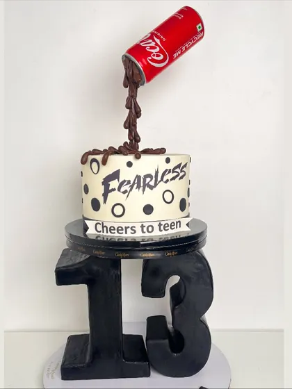We love playing with physics, and this gravity-defying cake is a perfect example. Featuring a sculpted number 13 base and a "pouring" Coca-Cola can, this design is engineered to create a fun and surprising illusion that gets everyone talking.