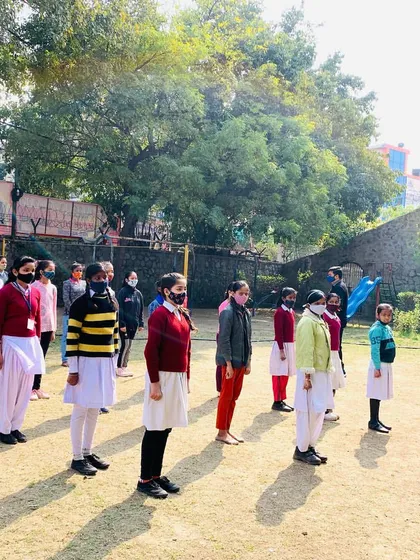 Students at Day Time Secondary School stand in formation, ready and attentive for the next instruction. This posture itself is a sign of newfound discipline and confidence.