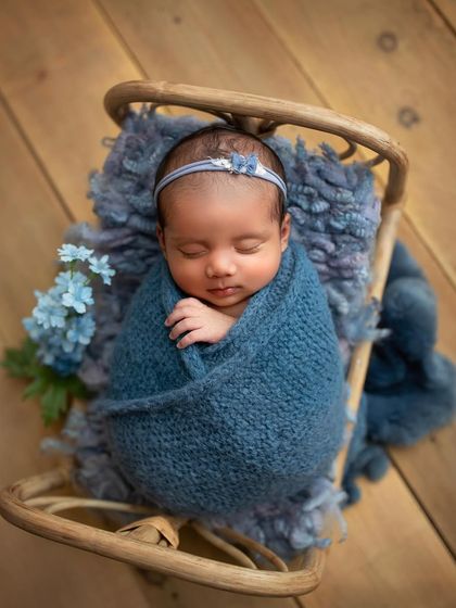 This overhead angle of the baby in a prop bed shows a different perspective you can capture from a single setup. We explore various angles to maximize the variety of shots from each scene.