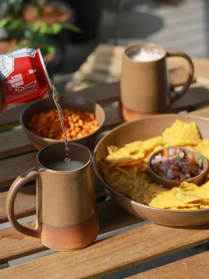 A student's barware collection, 'Moments Together,' inspired by cherishing gatherings with loved ones. This image shows beer mugs and snacks, creating a warm, inviting scene.