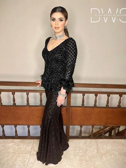 A confident pose from the client, her sleek ponytail adding to the overall chic and powerful look.