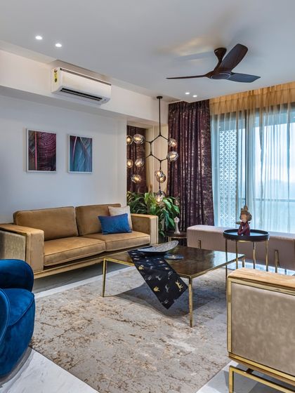 This perspective of the Filigree House living room highlights the connection to the outdoors. The large windows and sheer curtains allow ample light, making the space feel airy and connected to the view beyond.