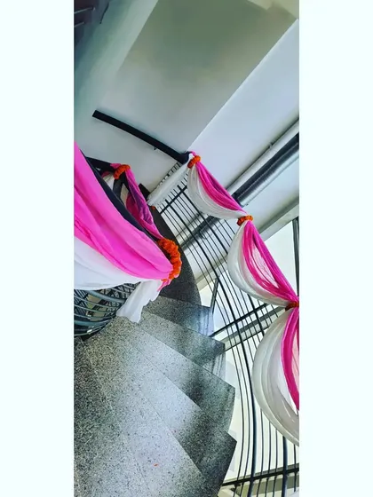 Even staircases get a festive makeover. We wrapped the railings with pink and white fabric and accented them with marigold bunches to ensure the decor theme was consistent across different floors.