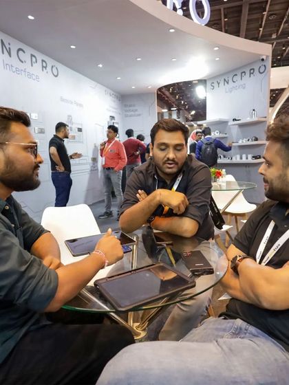 Meaningful conversations are what events are all about. Our team members are seen here in a deep discussion about smart home integration possibilities with visitors at our SyncPro booth.