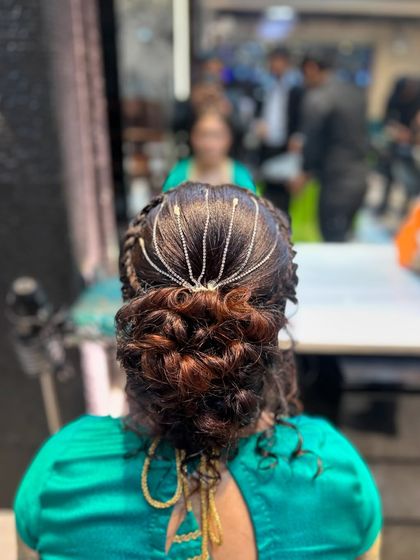 Another angle of the elegant messy bun, perfect for a cocktail or reception look.