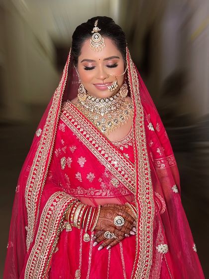 A moment of quiet contemplation for Divya. Her glittery eye makeup catches the light beautifully, adding a touch of glamour to her traditional look.