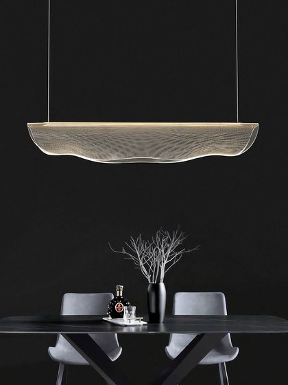 This linear suspension light has a unique, wave-like form made of a fine mesh. It's an ideal fixture for illuminating a modern dining table or a long conference table.