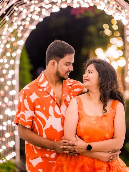 The light tunnel provides a perfect backdrop for a fun and colorful couple's shoot, with the bokeh lights adding a festive feel.